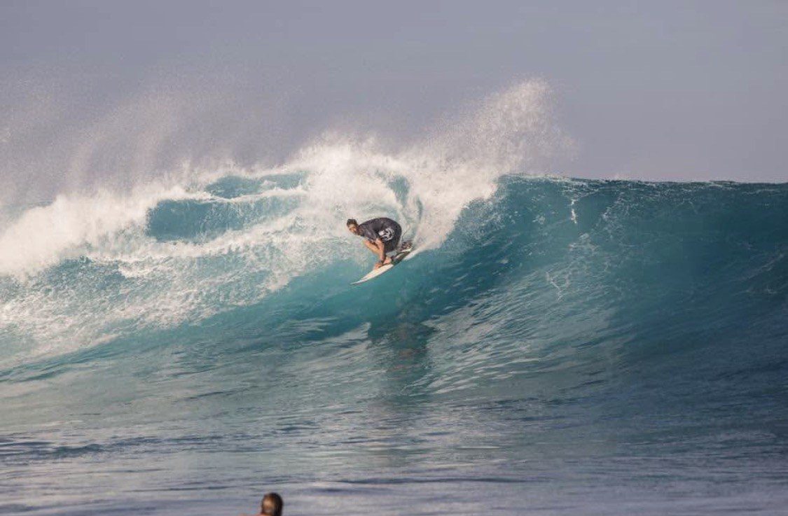 Pete dropping into a big turquoise Maui wave as it starts to barrel